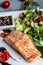 Grilled Salmon fish steak with fresh vegetables salad, Healthy salad for keto diet, friendly salmon with vegetables diet dish.