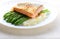 Grilled salmon garnished with asparagus and herbs and mashed potatoes