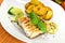 Grilled salmon steak with potato wedges