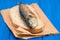 Grilled sardine on bread on blue wooden background