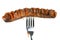 Grilled sausage decorated with ketchup pierced on a fork, isolated on white