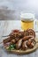 Grilled sausages and shish kebabs with a glass of  beer