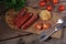 Grilled sausages with tomatoes and corn on a wooden table