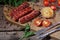 Grilled sausages with tomatoes and corn on a wooden table