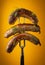 Grilled sausages with veal on a fork. Delicious lunch concept for hotel on yellow background