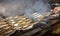 Grilled sea bass fish closeup. In process. European sea-bass, chef is grilling in the kitchen - BBQ