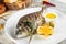 Grilled sea dorado fish with lemon creamy sauce