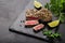 Grilled sesame tuna steak on black background