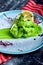 Grilled shrims and mashed mint with green peas close-up on a plate. closeup