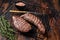 Grilled Sirloin flap or Bavette beef meat steak on a griil with herbs. Wooden background. Top view