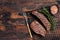 Grilled Sirloin flap or Bavette beef meat steak on a griil with herbs. Wooden background. Top view. Copy space