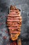Grilled sirloin steak on a cleaver. The cooking medium. Black background. Top view
