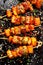 Grilled skewers with pineapple fruit and chicken meat  with sriracha sauce, sprinkled with sesame seeds, chilli pepper and fresh h