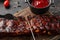 Grilled and smoked ribs with barbeque sauce. Delicious barbecued ribs. Food recipe background. Close up