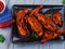 Grilled Spicy chicken wings on wooden table. Generative AI