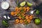 Grilled spicy lime shrimp skewers with creamy avocado garlic cilantro sauce. Top view, overhead, flat lay.