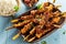 Grilled spicy seasoned satay skewers with herbs