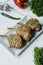 Grilled steaks from pork ribs with spices and herbs. Bone steak. Side view. Dark wooden background