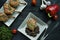 Grilled steaks from pork ribs with spices and herbs. Bone steak. Side view. Dark wooden background