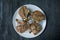 Grilled steaks from pork ribs with spices and herbs. View of the super Dark wooden background