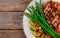 Grilled steaks, potato chips and asparagus on white plate