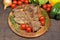 Grilled T bone steak with rosemary, tomatoes, corn, onions and