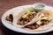 Grilled tacos with corn tortillas. Mexican food. Mexican food concept on wooden table. Traditional Mexican food. Grilled beef taco