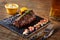 Grilled tenderloin Steak roastbeef and mushrooms sauce on black cutting board and glass of beer on wooden background