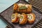 Grilled tiger prawn sushi. Japanese or Korean roll with different fresh ingredients. Trendy turquoise background