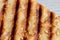 Grilled toast sprinkled with sesame seeds top view closeup