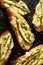 Grilled  toasts, bruschetta with addition of melted cheese, green asparagus, olive oil and herbs on a black background, top view.