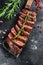 Grilled top blade, Denver steak. Marble meat beef. Black background. Top view