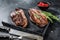 Grilled top sirloin cap or picanha steak on a stone chopping Board. Black background. Top view