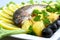 Grilled trout with potato, salad, black olives, lemon