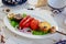 Grilled vegetables -  potato, tomato, bell pepper, eggplant and zuccini on skewer over a white plate