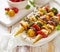 Grilled Vegetarian skewers with halloumi cheese and mixed vegetables sprinkled with fresh herbs