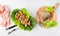 Grilled wild salmon and lettuce dish, linen, cutlery, fish on wooden board on white background, top view