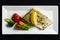 Grilled zander fillet with mixed grilled vegetables on white rectangular plate from above. Black background