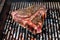 Grilling Big T Bone steak on natural charcoal barbecue grill