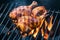 Grilling chicken pieces over coal fire for delicious barbecue