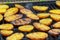Grilling delicious potatoes on barbecue. Slice potato are prepared on the grill on sunny day.