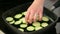 Grilling fresh zucchini in the black pan