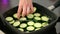 Grilling fresh zucchini in the black pan