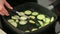 Grilling fresh zucchini in the black pan