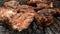Grilling Meat. Barbecue grilling juicy appetizing pork steaks on grate. Cooking food on weekend. Top-down food. Close-up.