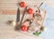 Grilling pork steaks, fresh vegetables and seasonings on cutting board