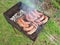 Grilling sausages on barbecue grill