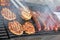 Grilling sausages, burgers, pork steak on barbecues gas grill for party. Hot dogs,sausages and hamburgers on a barbeque, bbq. Smok