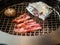 Grilling slices of beef with mushrooms and garlics.