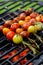 Grilling tomato skewers, skewers of colorful cherry tomatoes studded on rosemary sprigs with the addition of aromatic spices and s